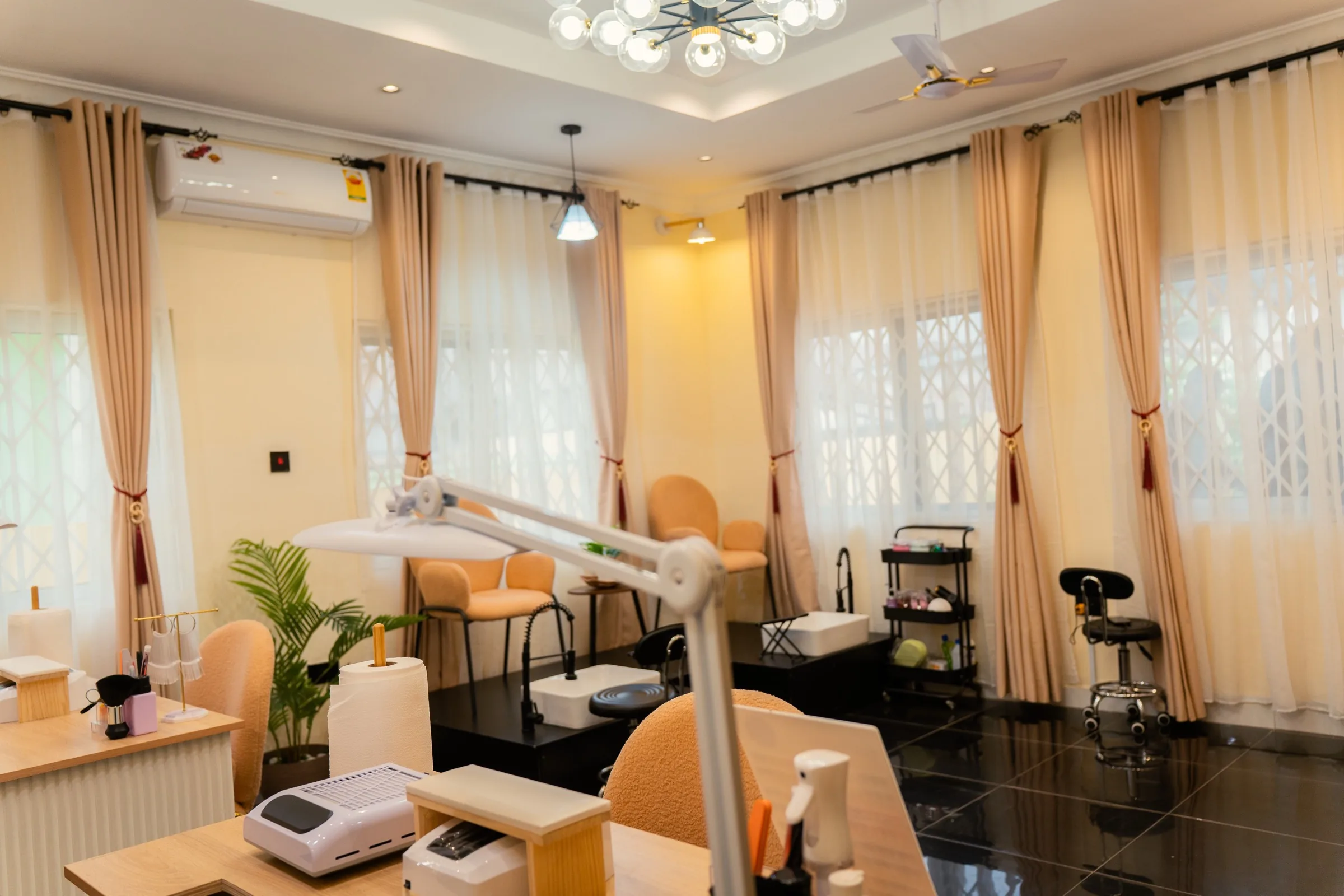 The Mink'd by Mya studio, with manicure and pedicure stations by curtained windows